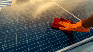 Solar panels being cleaned with a soft cloth