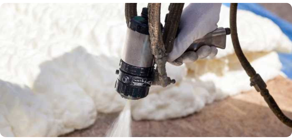 close up photo of a foam spray gun spraying foam sealant