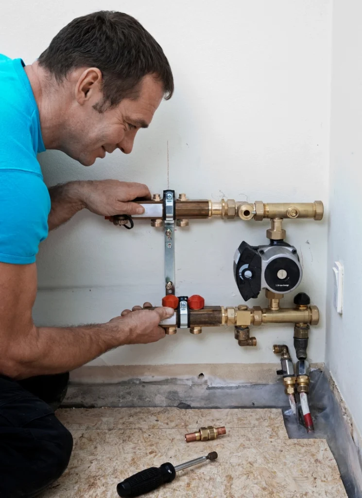 Technician installing a home floor Heat Pump